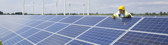 Man checking on solar panels