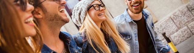 Men and women wearing different types of eyewear walking down a city street
