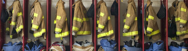 Firefighter suits hung in a row