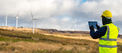 Employee testing wind turbine using device