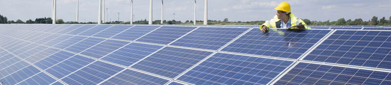 Man checking on solar panels