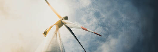 Looking up at a wind turbine