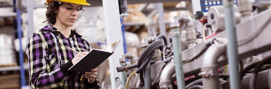 female engineer inspects industrial equipment