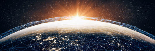 A series of interconnecting points of light across the earth, representing cybersecurity. 