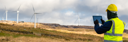 Employee testing wind turbine using device