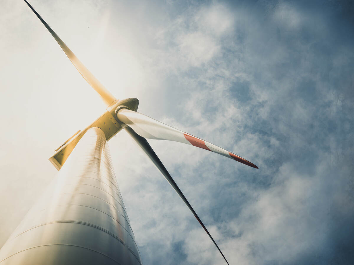 Looking up at a wind turbine