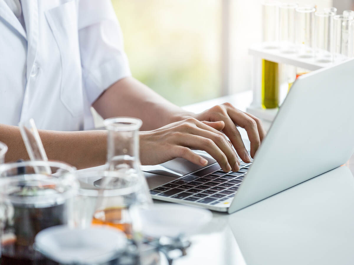 Person working on laptop at lab bench