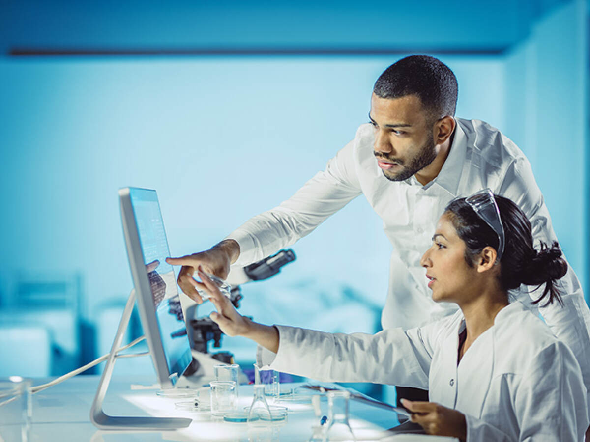 Scientists looking at computer