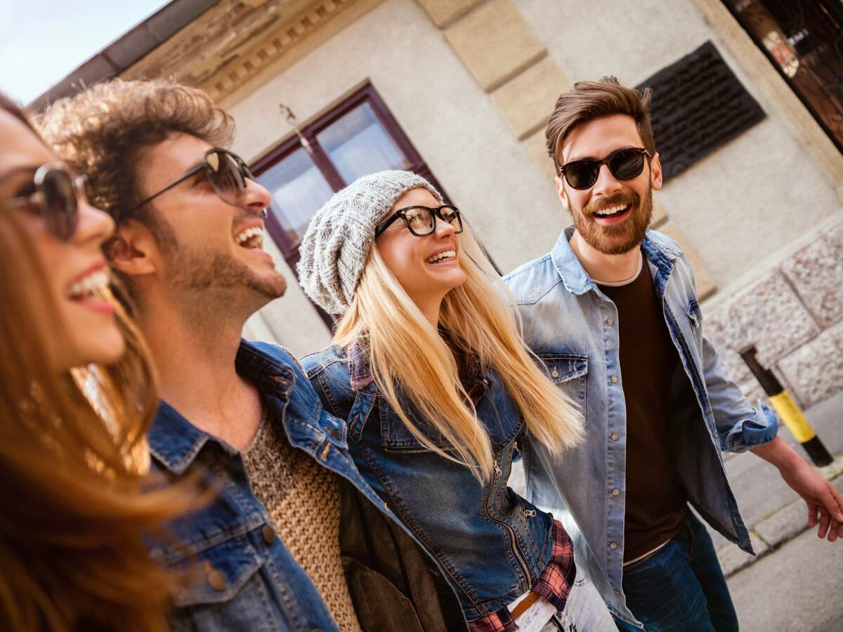 Men and women wearing different types of eyewear walking down a city street