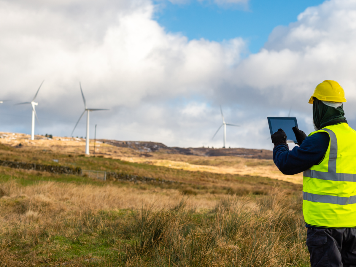 Employee testing wind turbine using device