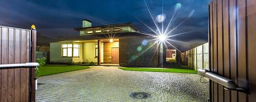 Luxury house with spotlight and electric gate security