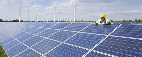 Man checking on solar panels