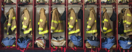 Firefighter suits hung in a row